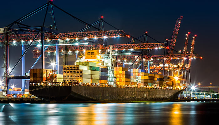 Cargo ship in New York container terminal at night. Credit: iStock/Ultima_Gaina