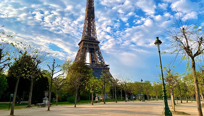 Scenic view of the Eiffel tower with bright blue sky in Paris, France. Empty Parisian streets during coronavirus quarantine and lockdown. Popular tourist destinations