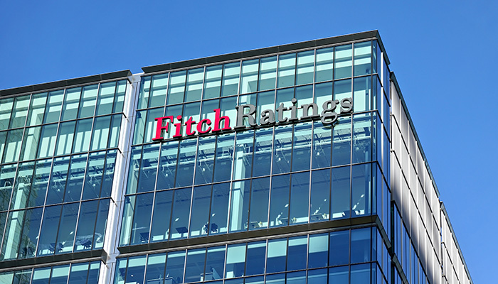 London, United Kingdom - February 03, 2019: Fitch Ratings logo signage at top of their Headquarters in UK (other is in New York), Canary Wharf. FR is one of the Big Three credit rating agencies