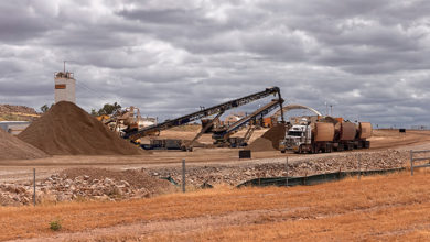 Clermont, Queensland, Australia - 04/27/2020; Working quarry with machinery and gravel with a truck being filled to supply the new Adani Carmichael mine in central Queensland, Australia.