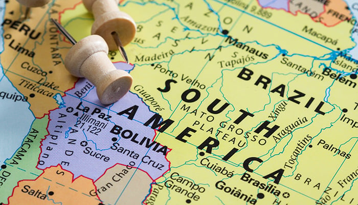 push pin on a world map marking Brazil as a destination concept