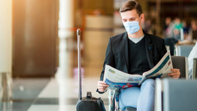 Man wearing a mask for prevent virus in international airport lounge waiting for flight aircraft. Protection against Coronavirus and gripp