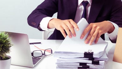 Businessmen are searching for documents lying on the table,business report papers,important documents.
