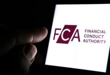 Stone / United Kingdom - March 4 2020: FCA Financial Conduct Authority logo on the smartphone and finger pointing at it in the dark room. FCA is a financial regulatory body in the UK. Concept.
