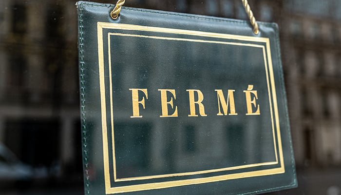 Sign at a shop window with the french text: "Ferme" that means "Closed"
