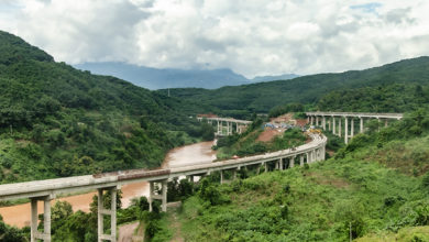 Belt and Road Initiative: Chinese Xiaomo Highway bridge under construction in the green jungle between Lao border town Boten and Mengla, Yunnan, China