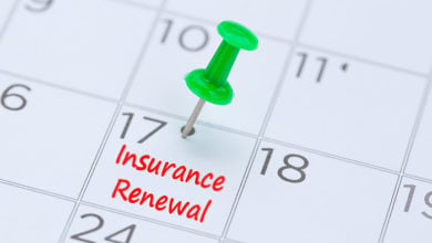 Insurance Renewal written on a calendar with a green push pin to remind you and important appointment.