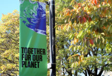 Glasgow, Scotland - October 21 2021: UN Climate Change Conference COP26 Banner in a Glasgow street with the words Together for Our Planet, with a tree in leaf behind it.