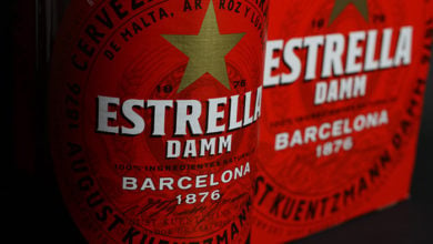 Viersen, Germany - July 9. 2020: Closeup of isolated red six pack and Estrella Damm spanish beer bottle (focus on center of bottle label)