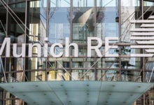 Munich, Bavaria / Germany - Mar 18, 2020: Close up of Munich Re logo / sign above the entrance of the LeopoldstraÃŸe offices. Munich Re is one of the largest Reinsurance companies in the world.