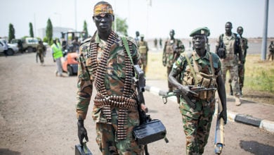 Paloch, South Sudan: A South Sudanese soldier carries a machine gun