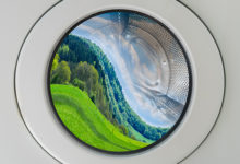 Concept symbol image greenwashing washing machine with deformed beautiful landscape inside