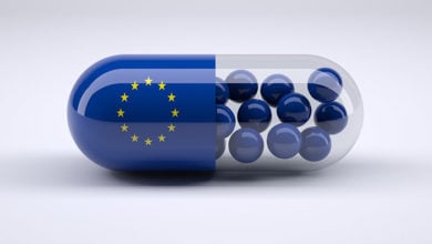 Pill with European flag wrapped around it and blue balls inside, 3d illustration