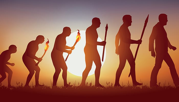 Concept of Darwinâ€™s theory of evolution, illustrated with the transformation of the human silhouette from primitive man to modern man.