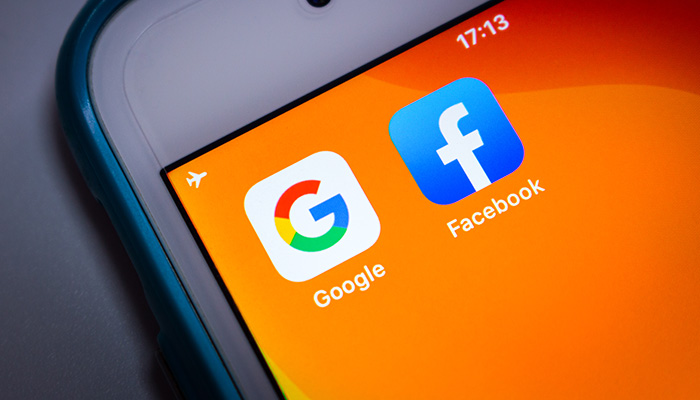 Kumamoto, Japan - May 21 2020 : Google & Facebook icons on orange iPhone screen on white background.