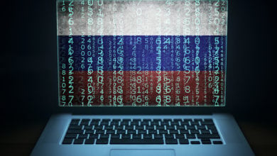 Russian hacker. Hacking laptop with binary computer code and russia flag on the screen. Internet and network security.