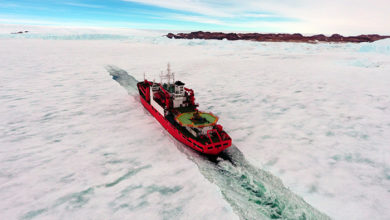 Cargo ship arrives in port for unloading on an ice floe. Antarctic.