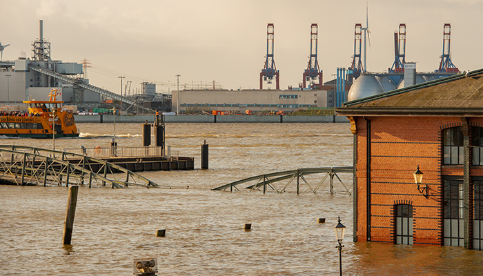Hamburg, Germany - January 30, 2022: Elbe flood and storm surge at the St. Pauli fish market, in the background the Hamburg Container Terminal Burchardkai