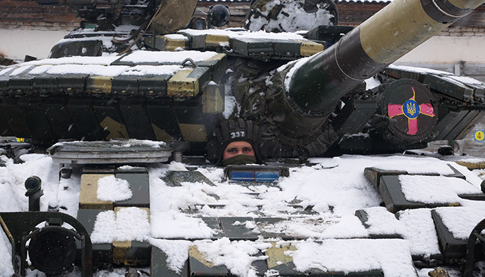 Kharkiv, Ukraine - January, 31, 2022: A tanker peeps out of the hatch of a T-64 tank. The Ukrainian army is preparing to defend itself against the invasion of Russia