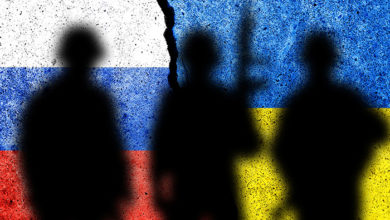 Flag of Russia and Ukraine painted on a concrete wall with soldiers shadows. Relationship between Ukraine and Russia