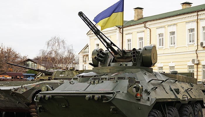 Army troops transporter and tank with Ukrainian flag, Ukraine - Russia war crisis concept, Kyiv