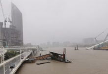 BRISBANE, AUSTRALIA - FEBRUARY 27, 2022: Wild weather and heavy rain falls from Tropical Cyclone storm Brisbane Central Business District. The North Quay ferry terminal is flooded and closed. Brisbane