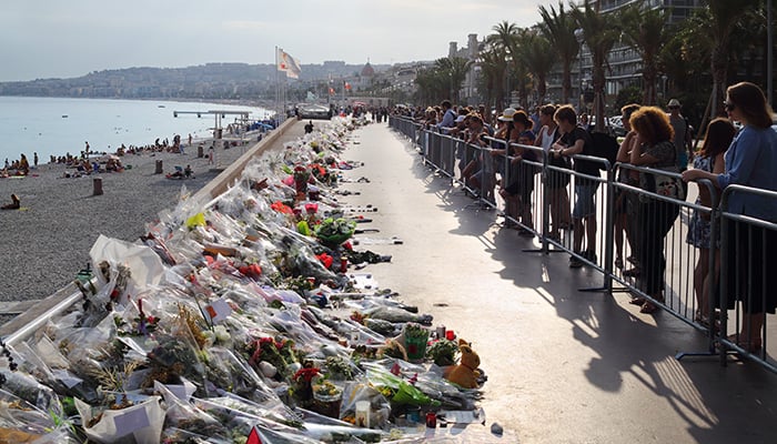 NICE, FRANCE - JUL 24, 2016: Flowers on quay after terrorist attack July 14, 2016, 86 people were killed under wheels of truck