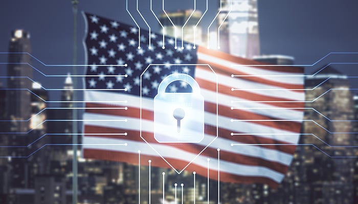 Double exposure of virtual creative lock hologram with chip on USA flag and blurry cityscape background. Information security concept