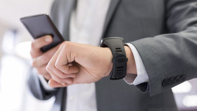 Man with Mobile phone connected to a smart watch