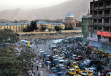 Kabul / Afghanistan - Aug 16 2005: A view of central Kabul, Afghanistan showing the market, traffic, crowds of people and distant hills. Kabul Market, people, mosque, hills, central Kabul, Afghanistan