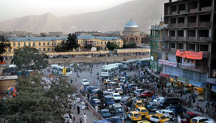 Kabul / Afghanistan - Aug 16 2005: A view of central Kabul, Afghanistan showing the market, traffic, crowds of people and distant hills. Kabul Market, people, mosque, hills, central Kabul, Afghanistan