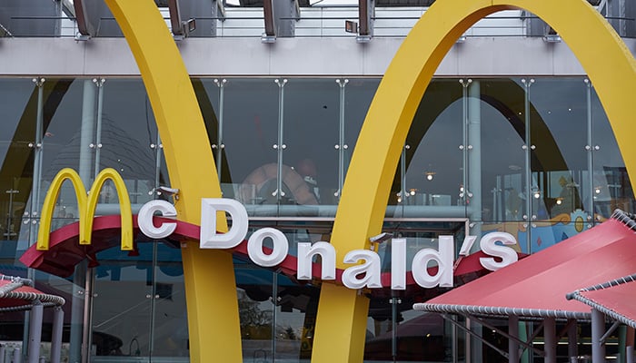 PARIS, FRANCE - November 09, 2019: McDonald's logo and exterior of restaurant in Paris. McDonald's is the world's largest chain of hamburger fast food restaurants.