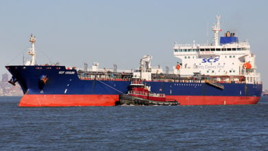 Staten Island, NY, USA - March 4, 2020: Oil Products Tanker SCF USSURI entering Kill Van Kull strait from the East, tugboat KIMBERLY TURECAMO by her side