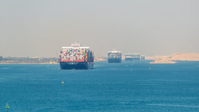Suez, Egypt - November 5, 2017: Large container vessels (ship) passing Suez Canal in the sandy haze in Egypt.