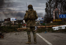 Irpin, Ukraine - 5 March 2022: Ukrainian soldier stands on the check point to the city Irpin near Kyiv during the evacuation of local people under the shelling of the Russian troops.