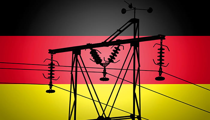 Concept Illustration With German Flag in the Background And old power line Silhouette in the foreground symbol for the upcoming energy crisis