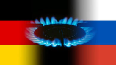 German and Russian flag and flames of blue gas.
