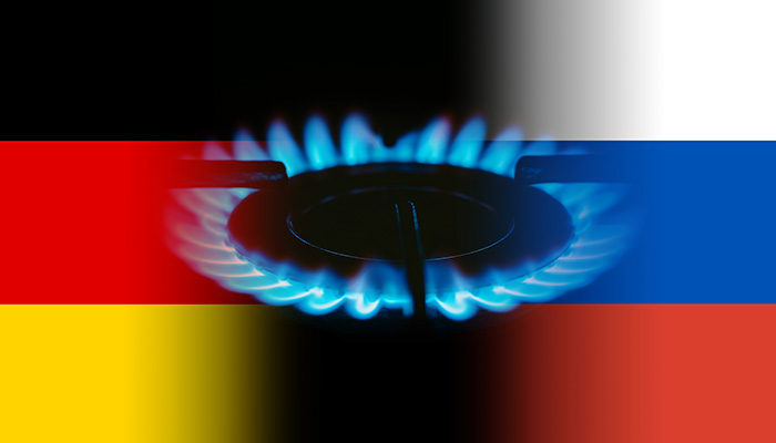 German and Russian flag and flames of blue gas.
