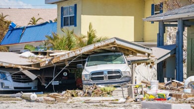 Fort Myers, FL, USA - October 1, 2022: Truck pinned down under storm debris Hurricane Ian Fort Myers FL