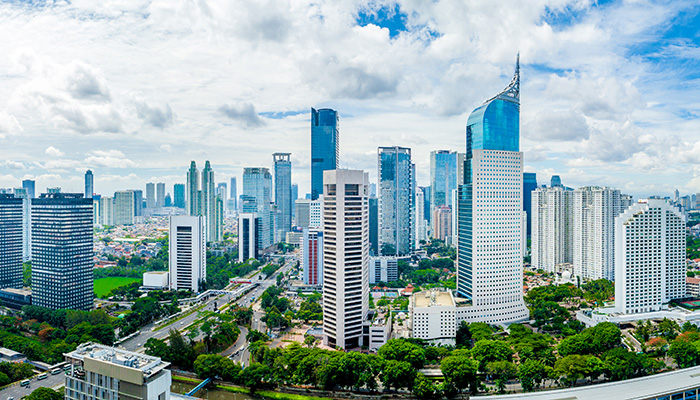 Aerial View of Jakarta Downtown Skyline with High-Rise Buildings With White Clouds and Blue Sky, Indonesia, Asia