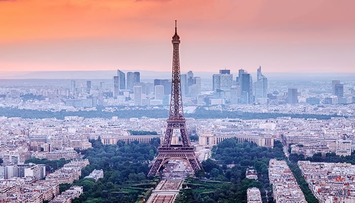 Paris, France. Panoramic view of Paris skyline with Eiffel Tower in the center. Amazing sunset scenery with dramatic sky.