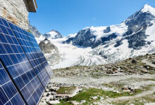 Close-up perspective snapshot of solar modules installed on the walls of alpine hut in Swiss Alps as alternative source of energy, concept of alternative energy