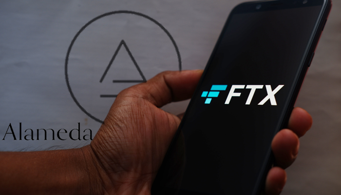 FTX on phone with Alameda logo in background