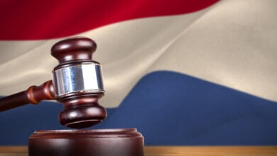 A court gavel in front of the Dutch flag