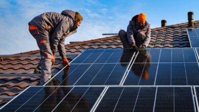 Workmen installing a solar panels on a Roof
