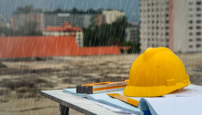 construction project in the rain with hard hat