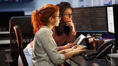 Zurich stock image of two women at a desk looking at a computer