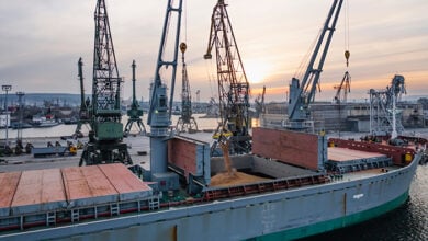 Black Sea Grain Initiative 2023 grain Deal. Silhouettes of port cranes during the loading of grain on a bulk carrier