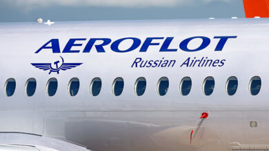 MOSCOW, RUSSIA - CIRCA JULY, 2017: Aeroflot Russian Airlines Sukhoi Superjet 100 twin jet engine passenger airplane side closeup fuselage view with aircraft windows logo lights landscape background