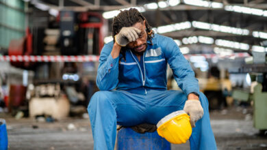 African American male technician feel tired from hard work in a repaired mechanic workshop manufacture